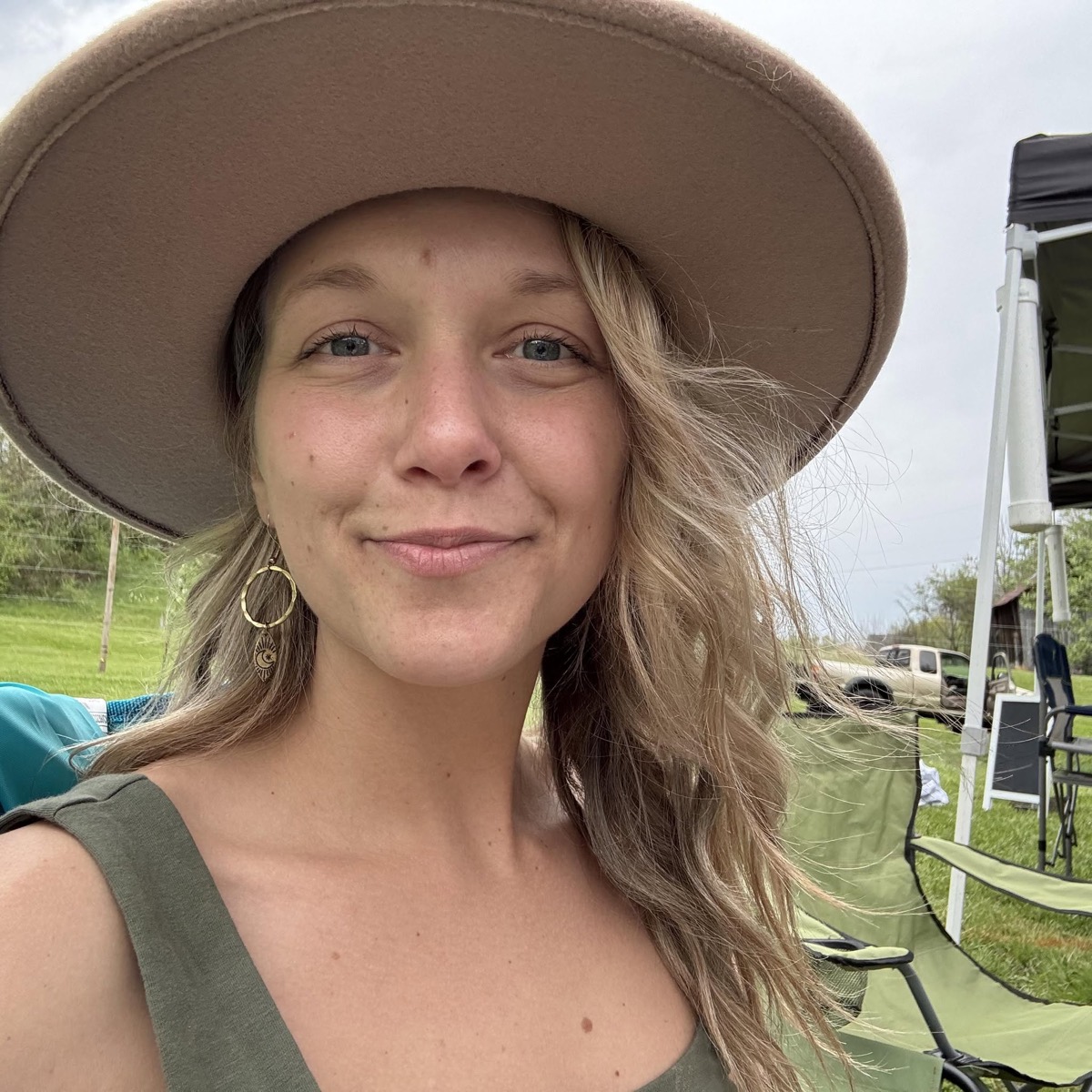Coda, the maker, at the market wearing her own pressed-flower earrings